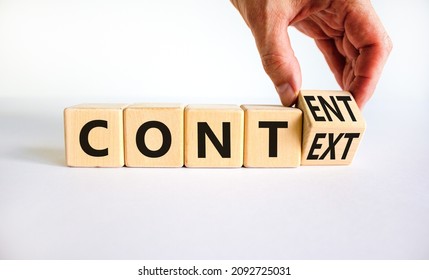 Content and context symbol. Businessman turns a wooden cube and changes the word context to content. Beautiful white table, white background. Business and content and context concept. Copy space.