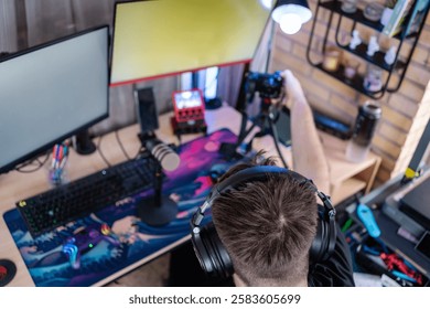 Content creator adjusting camera before starting live streaming on his gaming setup