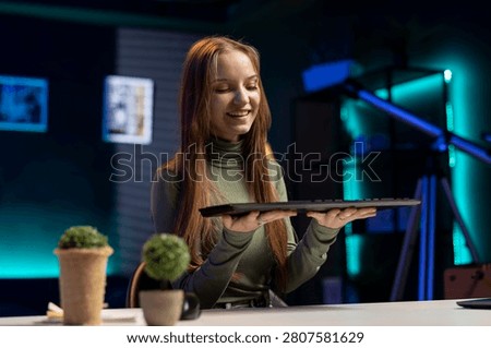 Content creator girl testing wireless keyboard on vlog, showing buttons and accessory compatibility, content creator filming a sponsored review video, sharing advice while promoting product.