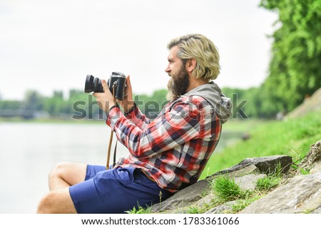 Content creator. Man bearded hipster photographer hold vintage camera. Masterpiece shot. Man with beard shooting photos. Photographer concept. Photographer amateur photographer nature background.