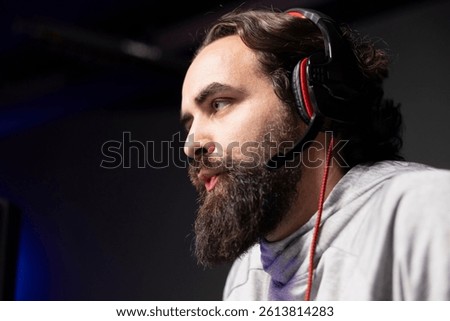 Content creator talking with viewers while playing online multiplayer videogame on gaming PC, contending against other live esports pro players. Close up shot of pro gamer streaming game