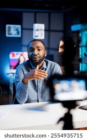 Content creator using production camera gear to film motivational type video for fans. Online show host using professional microphone to share inspiring quotes to viewers