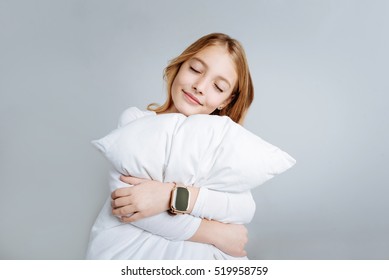 Content Cute Girl Embracing Pillow