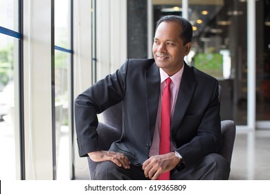 Content Indian Business Man Sitting In Armchair