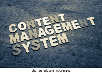 Content Management System text on wood background