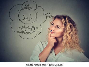 Content young woman is taken and idea having child while posing gray  