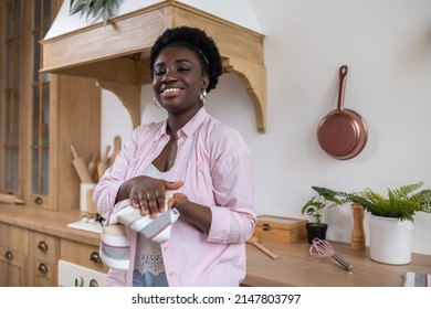 Contented African Woman In Pink Clothes Drying Hands