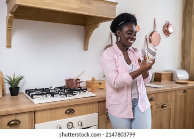 Contented African Woman In Pink Clothes Drying Hands