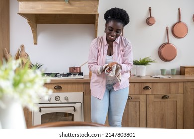 Contented African Woman In Pink Clothes Drying Hands