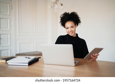 A Contented Woman Of Afro Appearance. A Woman Keeps Online Accounting Of Expenses For A Month At Home. Records Costs In A Convenient App.