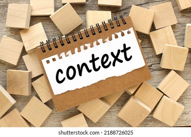 CONTEXT. text on paper. on wooden blocks. wooden background - Shutterstock ID 2188726025