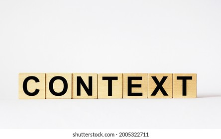 CONTEXT Word written on wooden cubes and a white background.