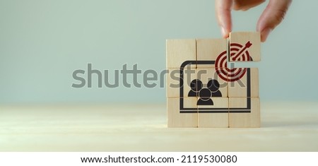 Contextual advertsing and targeting concept. Digital marketing strategy and social network advertsing. Personalized marketing.  Hand holds the wooden cubes with goal and contextual advertising icons.