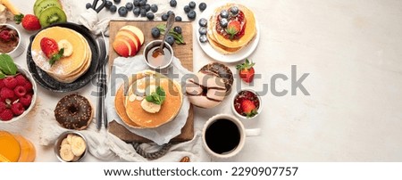 Continental breakfast. Coffee, jam, pancakes, maffins. White background. Family breakfast table. Top view. Panorama with copy space.