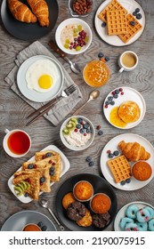 Continental Breakfast . Coffee, Tea, Croissants, Jam, Egg, Pancakes, Maffins And Oatmeal. Wooden Background. Family Breakfast Table. Top View
