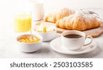 Continental breakfast with fresh croissants, orange juice and coffee, selective focuse.