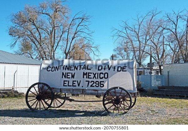 Continental Divide, New Mexico - November 7 2021:\
signage for the Continental Divide in New Mexico is placed on an\
old-style covered\
wagon.