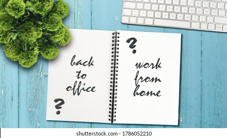 Continue Working From Home Or Going Back To The Office Concept With Note Pad And Computer Keyboard On Rustic Wooden Table