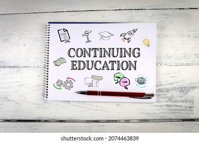 Continuing Education, Business Concept. Notebook On A White Wooden Table