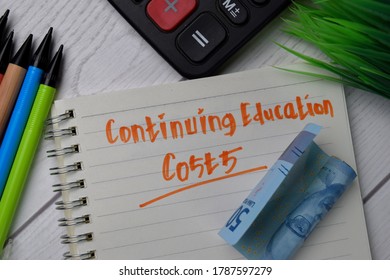 Continuing Education Costs Text Write On A Book Isolated Wooden Table.