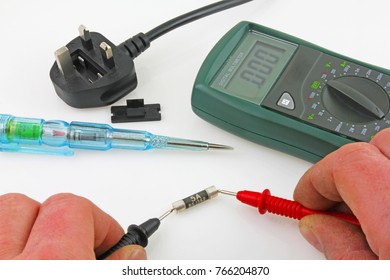 Continuity testing – An engineer testing  a fuse with a multimeter .
