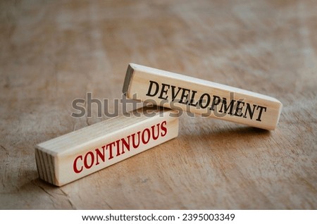 Continuous development text on wooden blocks. Development concept.