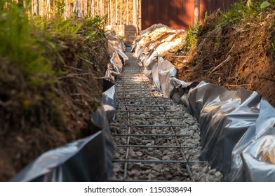 Continuous footing with reinforcement for the fence - Shutterstock ID 1150338494