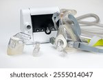 Continuous positive airway pressure system includes of CPAP machine, mask, tube on white background.