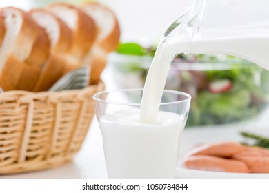 Continuous pouring of breakfast milk - Shutterstock ID 1050784844