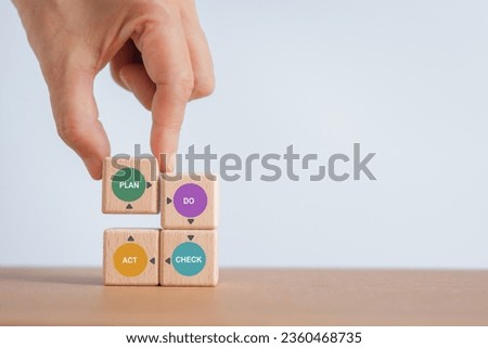 For continuous quality improvement model of four key stages (Plan, Do, Check, Action or PDCA), efficiency concept. Solving problems, improving organization  process. Hand completed wooden cube blocks