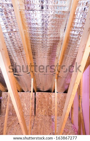 Continuous work of insulating of attic with reflective heat barrier between the attic joists and knee wall
