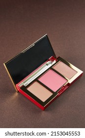 Contouring Palette. Blush, Highlighter And Bronzer On Brown Background