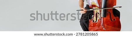 Contrabass player trying to play stringless double bass with copy space
