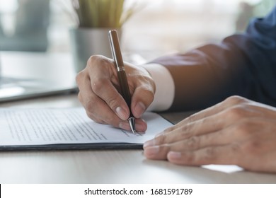 Contract document official. Close up person signing his signature to agreement document to guarantee financial loan. - Shutterstock ID 1681591789