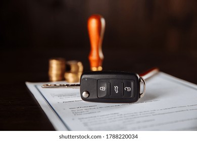 Contract Form For Car Loan, Stamp, Pen And Key On Wooden Table