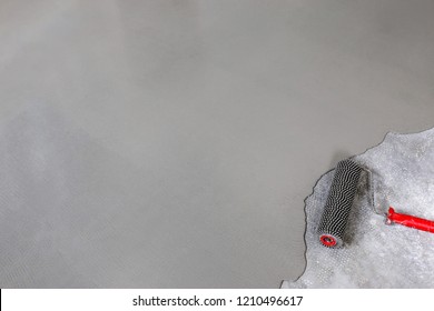 Contract Painter Painting Garage Floor To Speed Up Selling Of Home