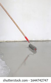 Contract Painter Painting Garage Floor To Speed Up Selling Of Home