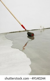 Contract Painter Painting Garage Floor To Speed Up Selling Of Home