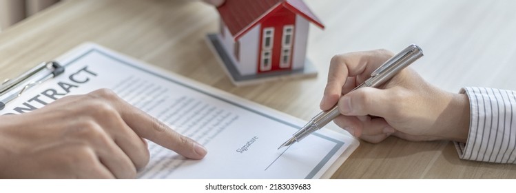 Contract signing, Home broker or salesperson allows customers to sign a contract to purchase a home as a legitimate homeowner, Transfer of ownership, Buy a new house. - Shutterstock ID 2183039683