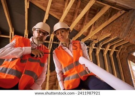Contractor and building inspector posing for camera during home inspection