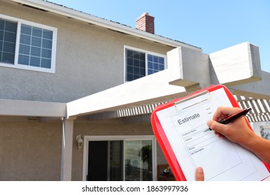 Contractor With Clipboard Writing An Estimate For Outdoor Home Improvements. 