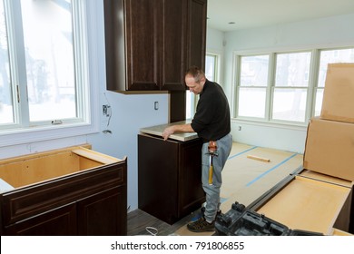 Contractor Installing A Laminate Counter Top During A Kitchen Remodel