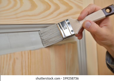 Contractor Painting A Wooden Door