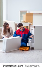 Contractor repairman assembling furniture under woman supervision - Shutterstock ID 1012898341