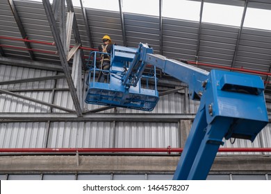 Contractor Technician Install Fire Sprinkler System. In The Industrial Plant, Pipe Assembly With Water, Red Fire Pipe, Fire Protection Suppression Contractors Using Scissor Lift High Work In Office 