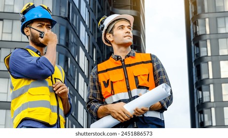 Contractor, Two civil engineers checking information from blueprint with shaking hands after outdoors meeting, project manager planning and collaboration, urban development in city - Powered by Shutterstock