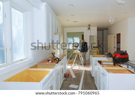 Contractor Using Circular Saw Cutting Crown Moulding for Renovation.