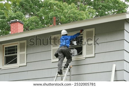 contractor working on replacing the window of the house