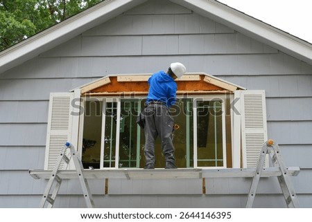 contractor working on replacing the window of the house