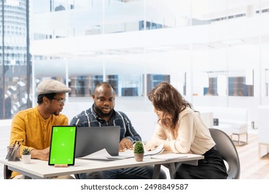 Contractors team showing office space sketch next to isolated chroma key, reviewing blueprint plans with a client. Real estate experts securing a contract after reaching a rental agreement. - Powered by Shutterstock